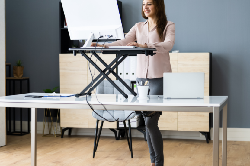 Standing desk ergonomics - Young Caucasian woman using her standing desk at home